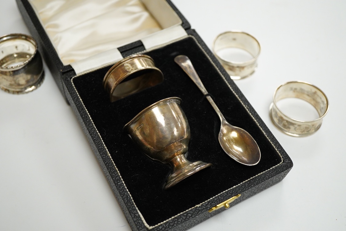 An Elizabeth II cased silver christening trio, Birmingham, 1959/60, together with three silver napkin rings.